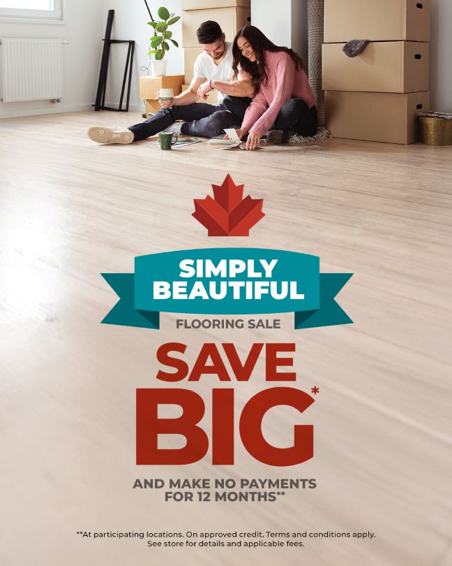 Advertisement picture showing a mand and woman sitting on the floor looking at colour swatches. Carpet One is having the The Simply Beautiful Flooring Sale.